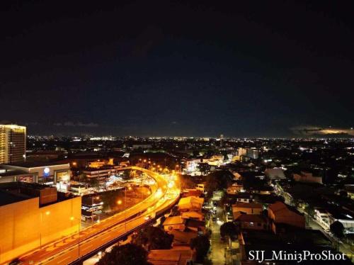 a city lit up at night with traffic on a highway at Sky Suites at Spring Residences Condotel near NAIA and SM Bicutan Mall in Manila