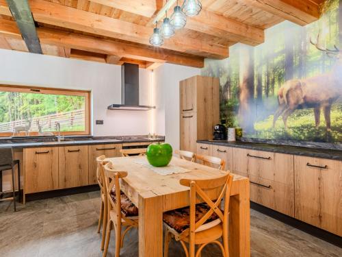 a kitchen with a table with a green apple on it at Apartment Larice Bilocale by Interhome in Livo