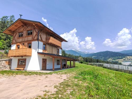a small house with a wooden roof on a hill at Apartment Larice Bilocale by Interhome in Livo