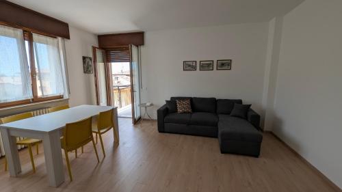a living room with a couch and a table at Apartment with great views on Lake Garda in Torri del Benaco