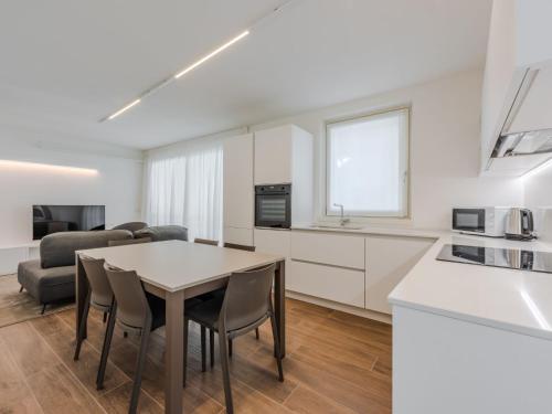 a kitchen and living room with a table and chairs at Apartment Maria by Interhome in Pinzolo