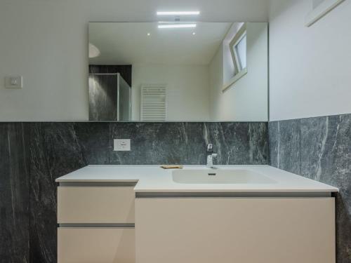 a bathroom with a sink and a mirror at Apartment Maria by Interhome in Pinzolo