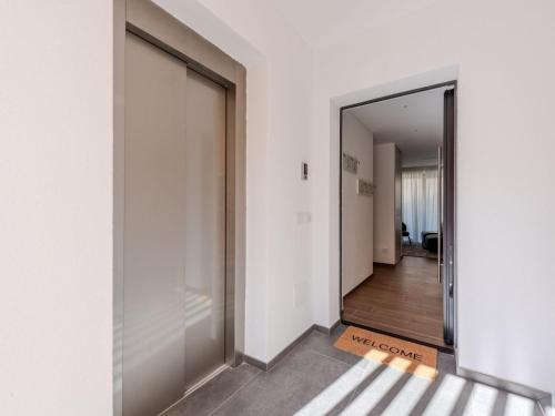 a hallway with a large glass door and a hallway leading into a room at Apartment Maria by Interhome in Pinzolo