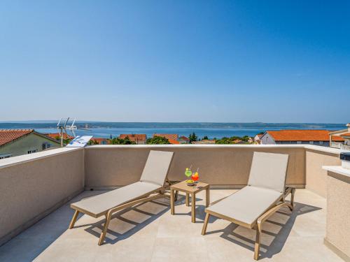 a patio with two chairs and a table on a balcony at Villa Ivica & Marica by Interhome in Maslenica