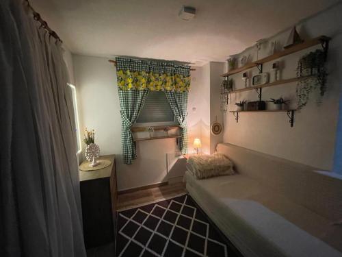 a small room with a bed and a window at Property with your own beach and pool - Whispering Waters in Krupa na Vrbasu