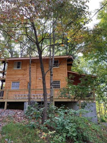 a wooden house with a tree in front of it at Hickory Ridge - HotTub - GSMNP, NOC, Train and Fontana Lake in Almond