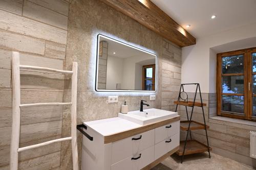a bathroom with a sink and a mirror at Charmante Altbauwohnung mit Flair in Polling in Polling