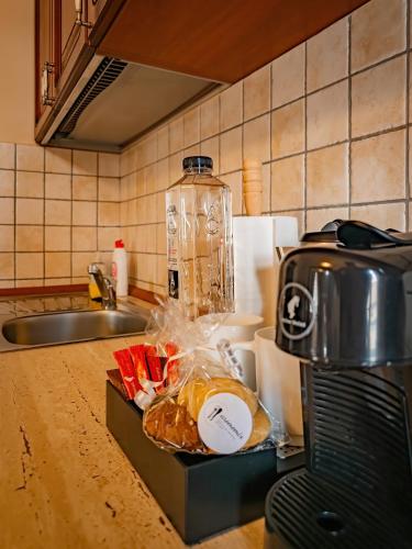 a kitchen counter with a toaster and some food at Aparthotel Iosefin Residence in Timişoara