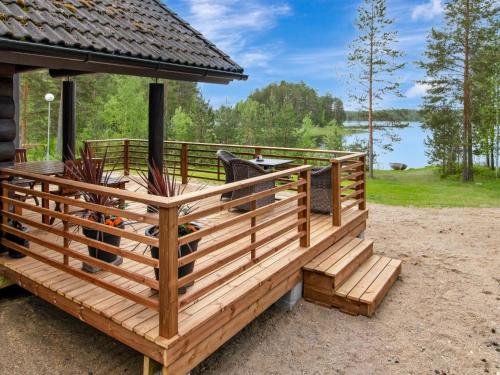 a large wooden deck with a gazebo at Holiday Home Paloniemi by Interhome in Savitaipale