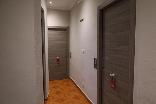 an empty hallway with two doors in a room at Hostal Victoria in Málaga