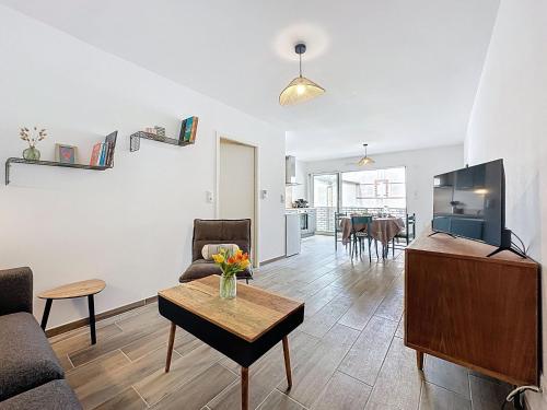 a living room with a couch and a tv and a table at Apartment Océanide-2 by Interhome in La Bernerie-en-Retz