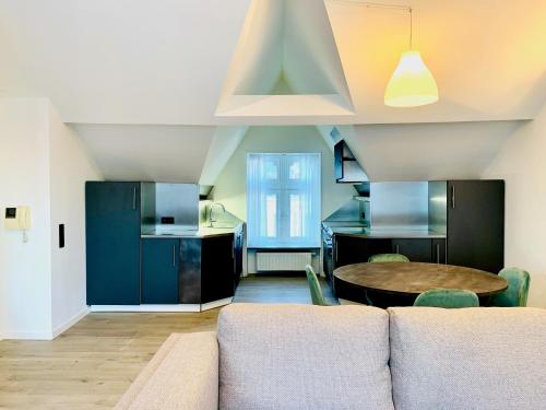 a living room with a couch and a table at Belfort Shortstay in Ghent
