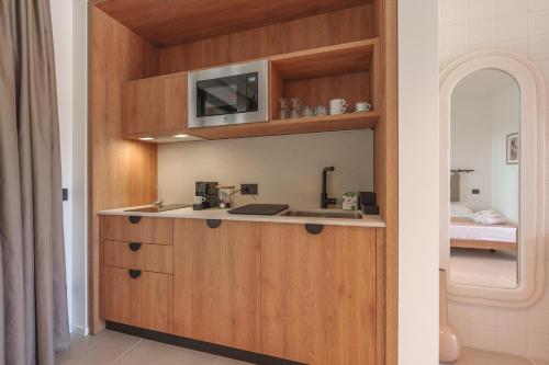 a kitchen with a sink and a microwave at Campoblù in Marina di Campo