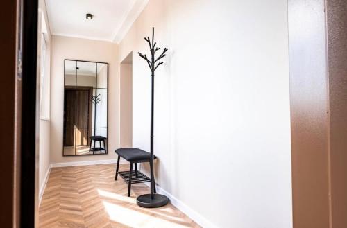a black chair in a hallway with a mirror at River View Ruse, Free Parking in Ruse
