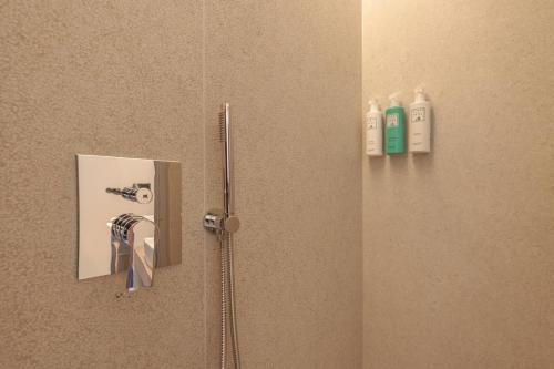 a bathroom door with a mirror and a toothbrush at Campoblù in Marina di Campo
