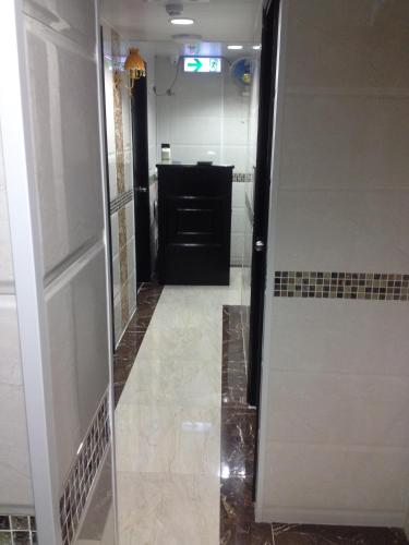 a bathroom with a walk in shower and a mirror at Manhattan Guesthouse in Hong Kong