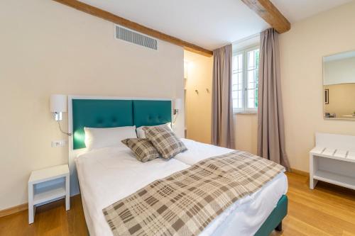 a bedroom with a large bed with a blue headboard at Al Torrione in Collecchio