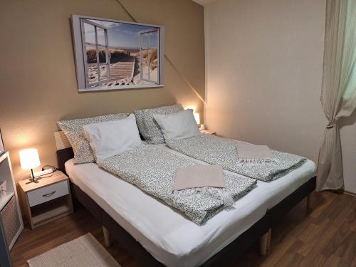 a bedroom with a bed with a picture on the wall at Haus Hoogendam in Leoben