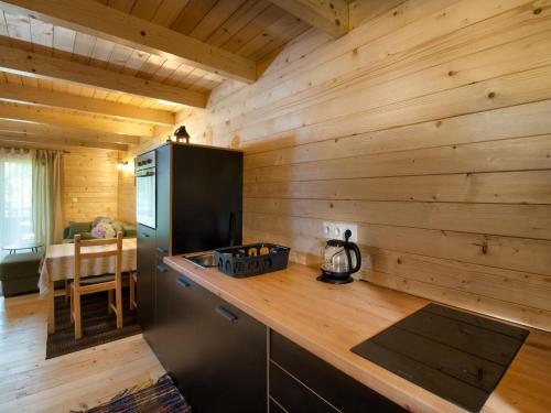 a kitchen with wooden walls and a wooden counter top at Chalet Jela by Interhome in Karlovac
