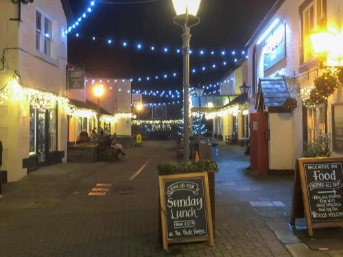 an empty street at night with christmas lights at Courtyard View in Keswick