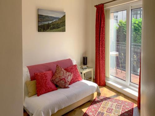 a living room with a couch and a window at The Stable View in Bowness-on-Windermere