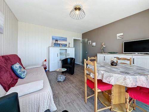 a living room with a table and a couch at Apartment Le Sextant by Interhome in Saint-Michel-Chef-Chef