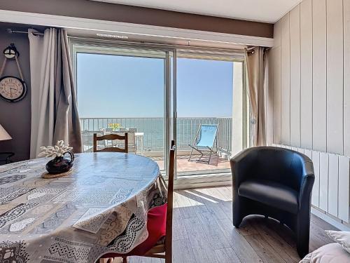 a room with a table and a view of the ocean at Apartment Le Sextant by Interhome in Saint-Michel-Chef-Chef