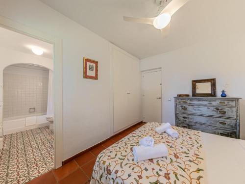 a bedroom with a bed with two towels on it at Villa Las Codornices-2 by Interhome in Sanlúcar la Mayor