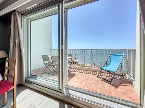a room with a balcony with a view of the ocean at Apartment Le Sextant by Interhome in Saint-Michel-Chef-Chef