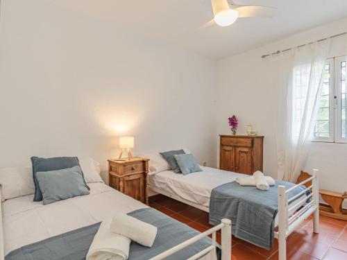 a living room with two beds and a window at Villa Las Codornices-2 by Interhome in Sanlúcar la Mayor