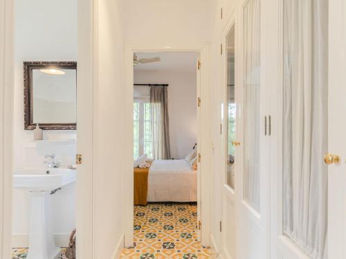 a bathroom with a sink and a bedroom at Villa Las Codornices-2 by Interhome in Sanlúcar la Mayor
