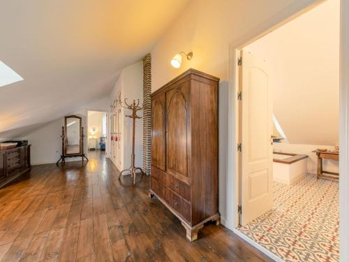 an attic room with a large wooden cabinet and a hallway at Villa Las Codornices-2 by Interhome in Sanlúcar la Mayor