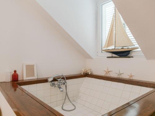 a bathroom with a bath tub with a sailboat on a window at Villa Las Codornices-2 by Interhome in Sanlúcar la Mayor