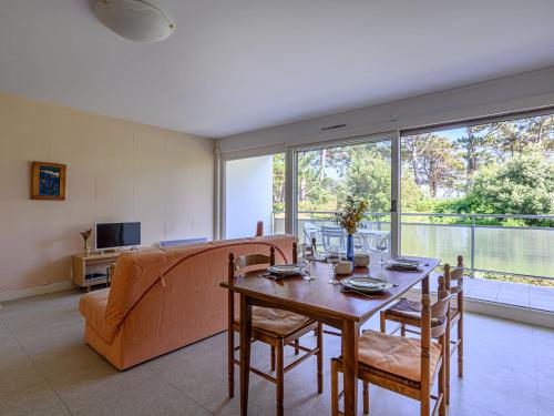 a living room with a table and a couch at Apartment Men Er Bellec-4 by Interhome in Saint-Philibert