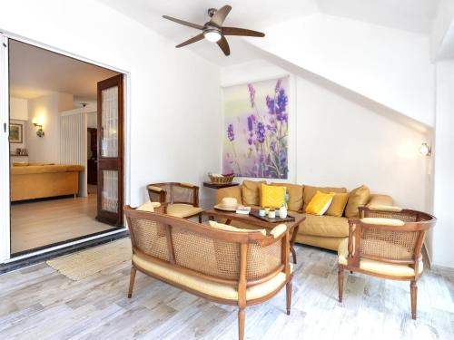 a living room with a couch and a table at Holiday Home Lu Nibbaru di Portobello by Interhome in Aglientu