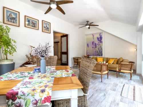 a dining room with a table and chairs at Holiday Home Lu Nibbaru di Portobello by Interhome in Aglientu