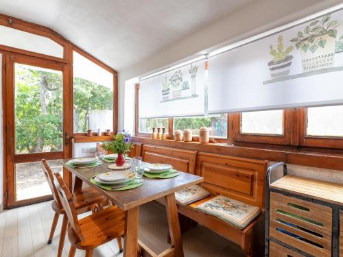 a dining room with a table and chairs at Holiday Home Lu Nibbaru di Portobello by Interhome in Aglientu