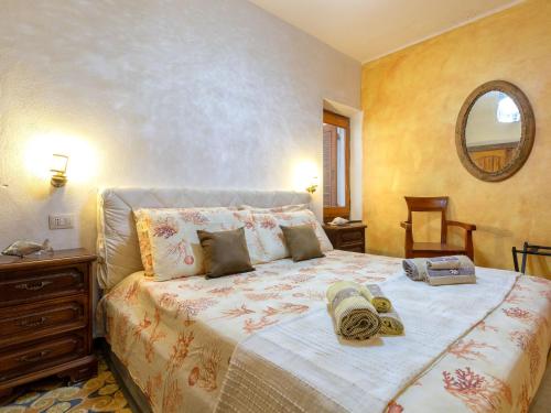 a bedroom with a large bed and a mirror at Holiday Home Lu Nibbaru di Portobello by Interhome in Aglientu