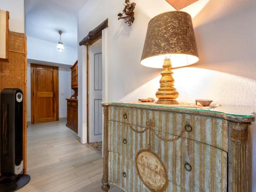 a lamp on top of a wooden dresser in a hallway at Holiday Home Lu Nibbaru di Portobello by Interhome in Aglientu