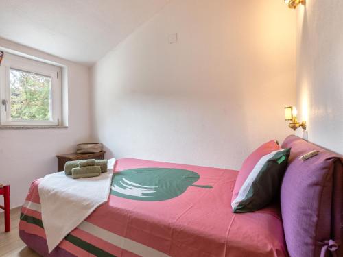 a bedroom with a bed with a colorful blanket at Holiday Home Lu Nibbaru di Portobello by Interhome in Aglientu