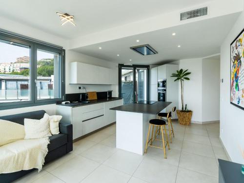 a kitchen and living room with a couch and a table at Apartment Entre Bateau et Mer by Interhome in Santo Stefano al Mare