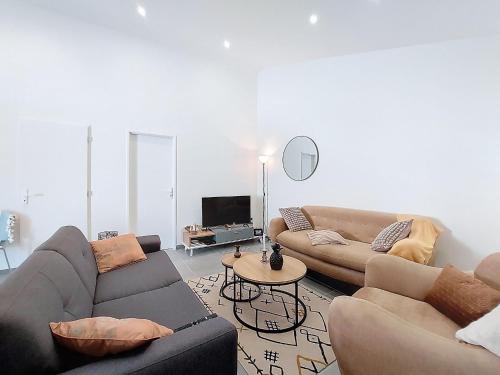 a living room with two couches and a tv at Holiday Home Maison du bois by Interhome in Les Mathes