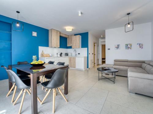 a kitchen and living room with a table and chairs at Apartment Dita-2 by Interhome in Crikvenica