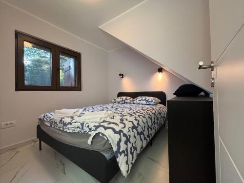 a bedroom with a bed in a room with stairs at Vila Limun in Divčibare