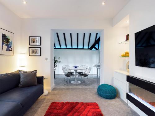 a living room with a couch and a table at No 3 at Upton Cross House, Chester in Backford