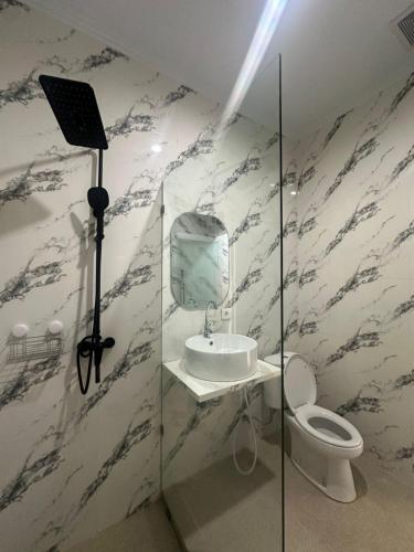 a bathroom with a mirror and a sink and a camera at Aldi's House Villa in Mantaak