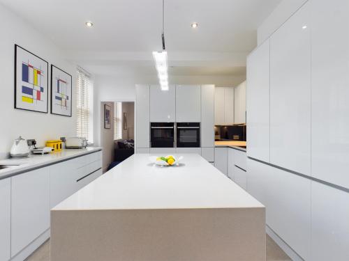 a kitchen with white cabinets and a white counter top at No 3 at Upton Cross House, Chester in Backford