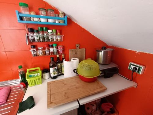 a kitchen counter with a yellow pot on a cutting board at Mansarda Eiretta in Ceres