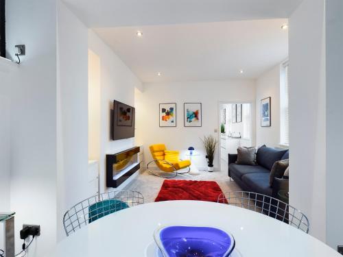 a living room with a couch and a table at No 3 at Upton Cross House, Chester in Backford