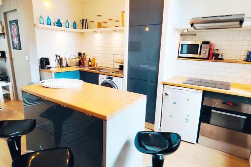 - une cuisine avec un comptoir et des tabourets dans l'établissement Nice T2 in the historic heart of Bordeaux, à Bordeaux